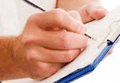 Picture of a person writing on new patient forms forms